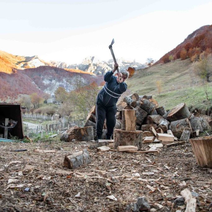 Albania, Lepushe, 2021-10-30. Burnesha Dune chops wood in her garden. As a Burnesha, Dune is considered a man by the community. Photograph by Alexander BEE / Hans Lucas. 
Albanie, Lepushe, 2021-10-30. Burnesha Dune coupe du bois dans son jardin. En tant que Burnesha, Dune est consideree comme un homme par la communaute. Photographie d Alexander BEE / Hans Lucas.